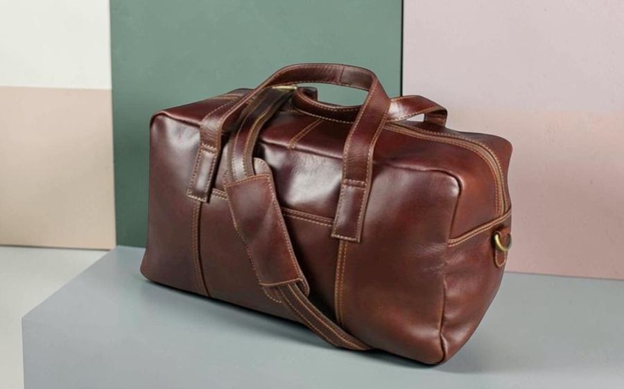 Black leather duffel bag with pockets